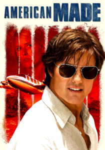Tom Cruise as Barry Seal smiling in a pilot's uniform with a suitcase of cash in American Made.